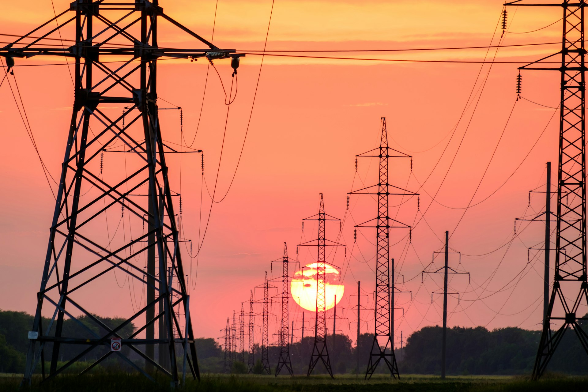 Power lines silhouetted against a dusk sky